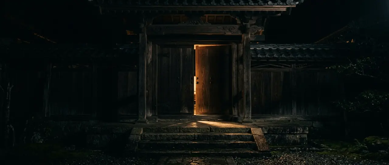 A temple door left ajar, warm light on the steps